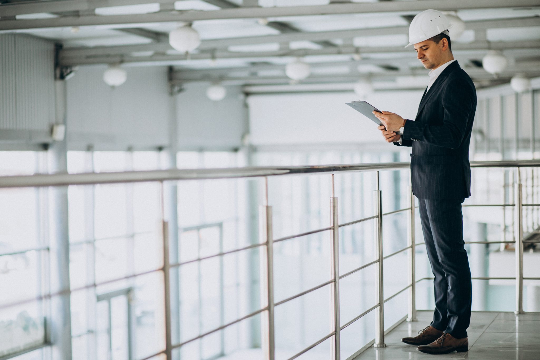 handsome business man engineer in hard hat in a building