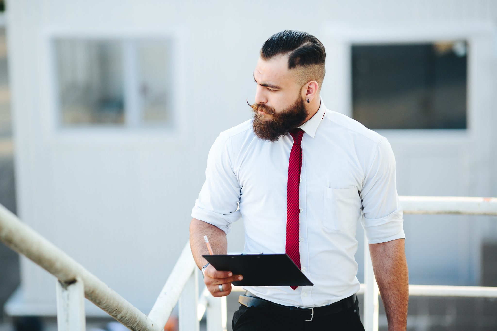 businessman stands with documents in hand